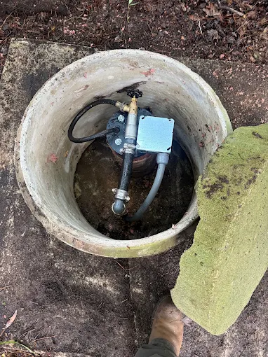 Jet pump with pressure switch and plumbing inside a concrete well pit