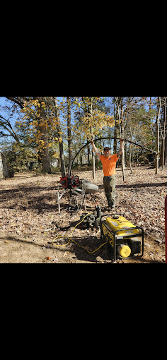 Flexing new poly pipe during a pump pull at a wooded job site