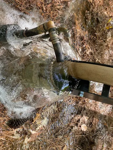 Water flushing from a well head at full flow after pump service