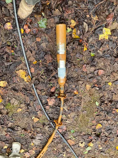 Close-up of a rusty failed submersible pump pulled from a well