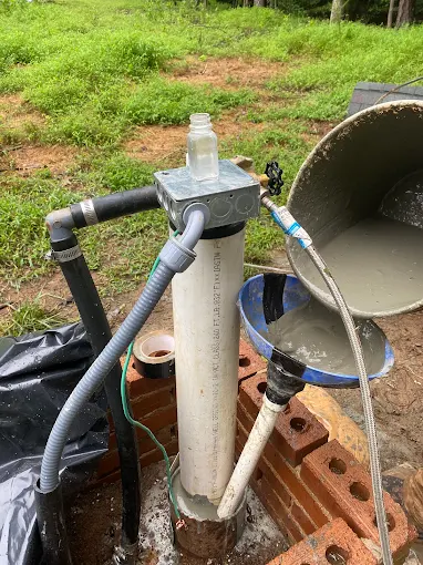 Well cap and pitless piping opened up mid-job with fresh grout