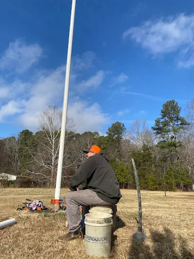 Setting a new drop pipe down a well on an open field job
