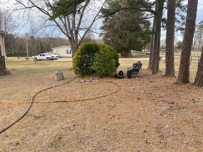 Water lines run across a rural yard during a well repair