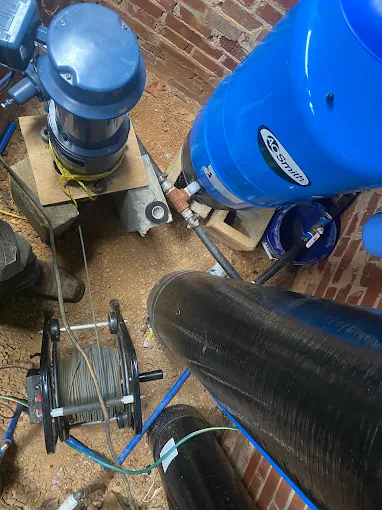 New submersible pump, pressure tank and cable reel staged for installation