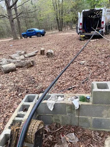 New drop pipe and wiring laid into a block well pit with the van close by