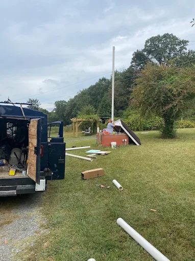 Service truck on site while setting new casing pipe at a well house
