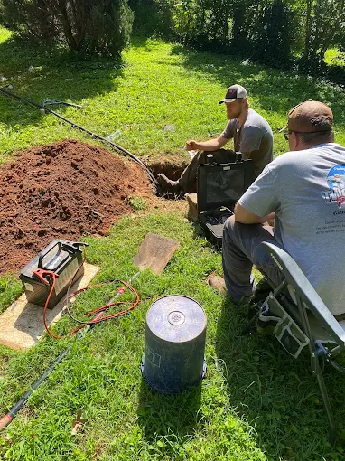 Shane and Joey trenching a new water line from a well to the house