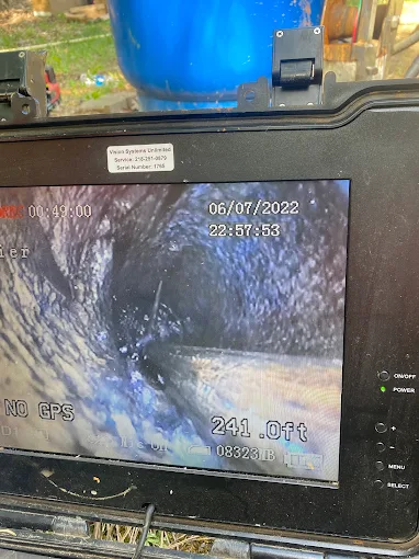 Well camera monitor showing the inside of a well casing at 241 feet deep