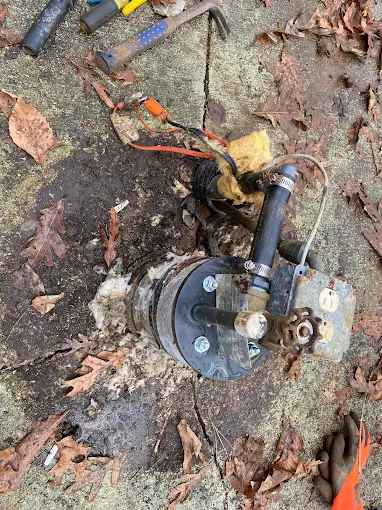 Pulled well pump and cap on a concrete pad, ready for service