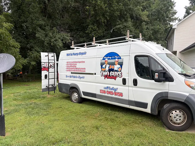 Two Guys service van parked on the lawn at a home during a well repair call