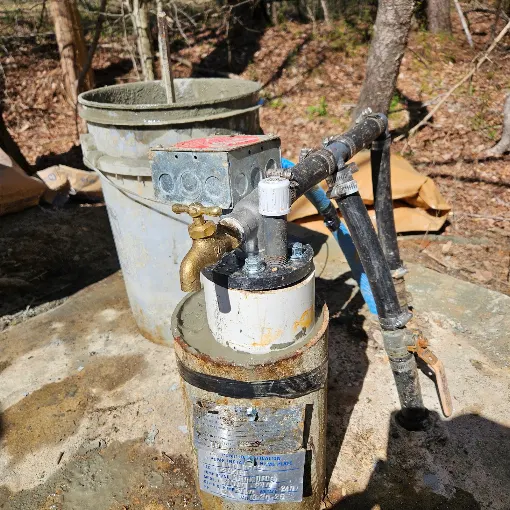 Well seal with a brass spigot and pressure switch plumbed on a casing