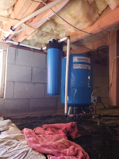 HydroPro pressure tank and whole-house filter installed in a crawl space
