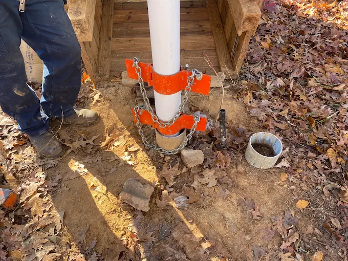 New PVC drop pipe clamped with pipe vises while pulling a submersible well pump