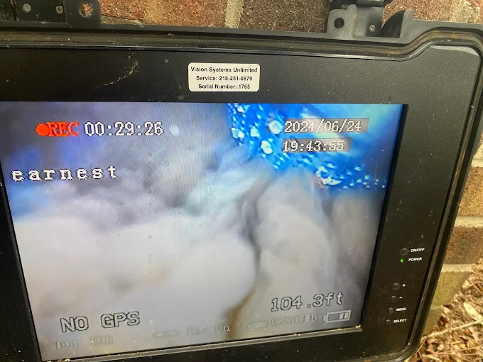 Downhole camera screen showing the inside of a well at 104.3 feet