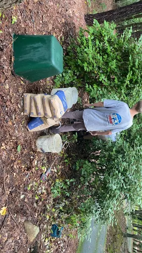 Carrying treatment supplies to a well house at the edge of the woods