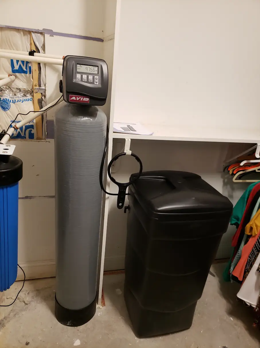 Water softener and brine tank installed for a well water system