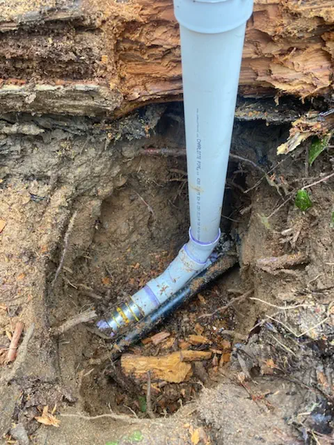 Excavated well water line and repaired supply pipe at a rural property