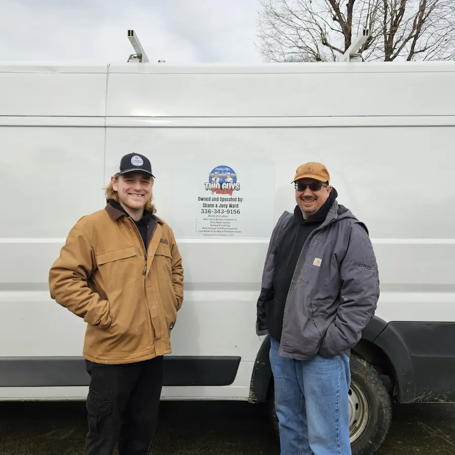 Shane and Joey Ward of Two Guys Plumbing at a well water tank in Mebane, NC